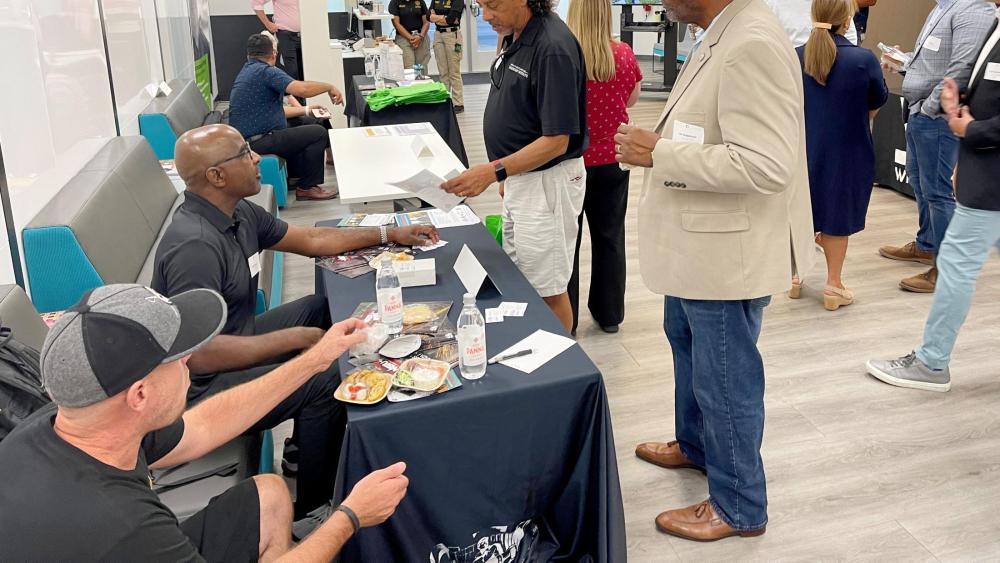 Community Engagement Meeting showing table and handing out information