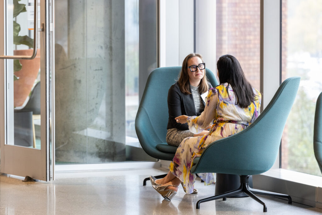 two women talking on chairs