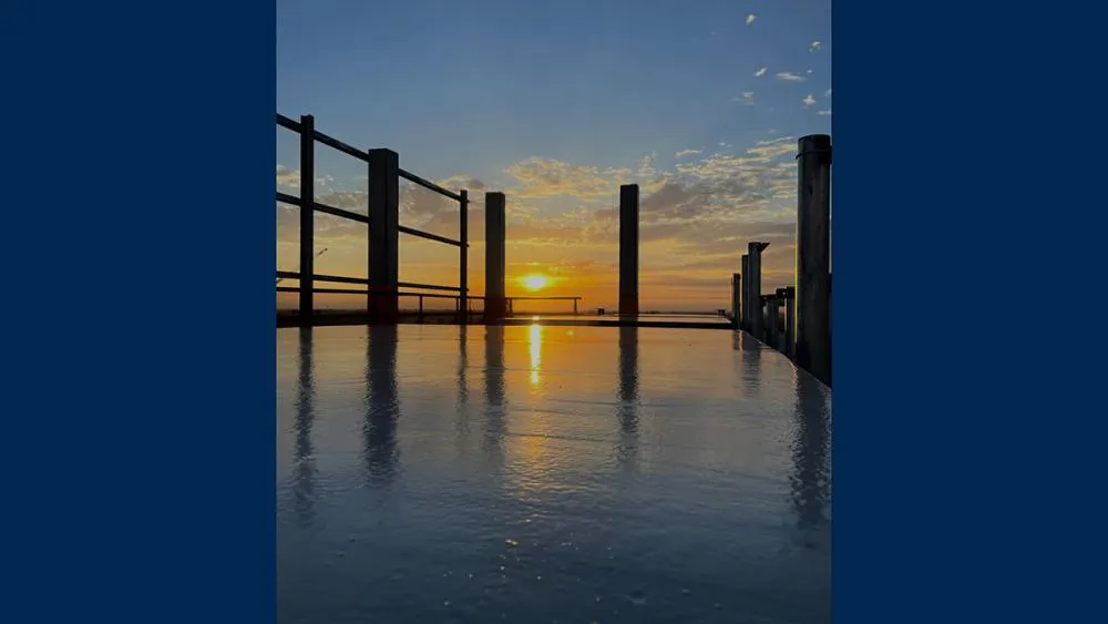 The second place August 2023 photo contest winner features a beautiful sunrise view atop of one of the buildings of Aggie Square. Photo by Jaden Swanson.