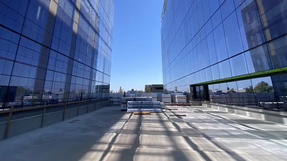 The second place winner for September 2023 shows the reflective glass of the Aggie Square buildings match the clear blue skies, contrasted against the gray concrete. Photo by Shawn Cooper.