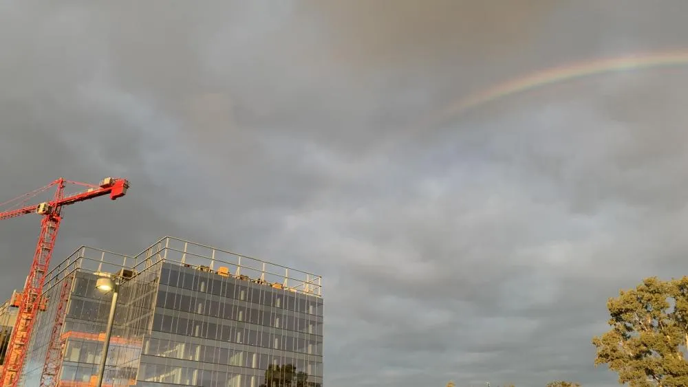 April 2024's first-place winner shoes a beautiful rainbow reaching over the Aggie Square construction site, the vibrant colors popping against the gray clouds. Photo by Scott Donaldson.