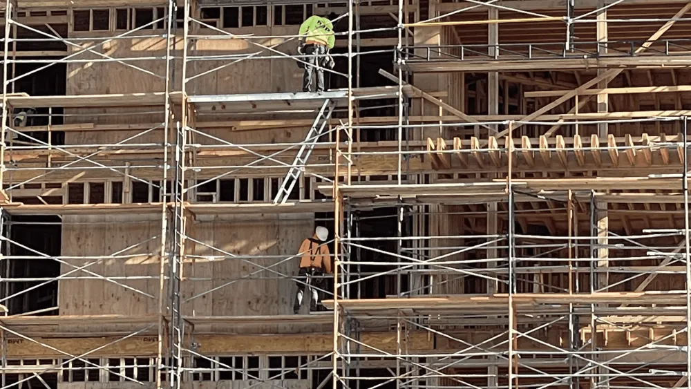 May 2024's second-place winner captures a moment of construction workers at the Aggie Square construction site, perfectly aligned with one another on different levels. Photo by Jordan Levin.