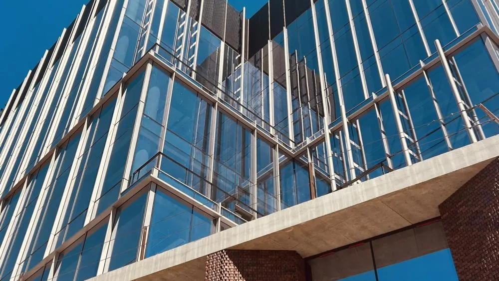 The second place winner for August 2024 takes a close look at the glasswork and brick of Aggie Square. Photo by Ryan Robinett.
