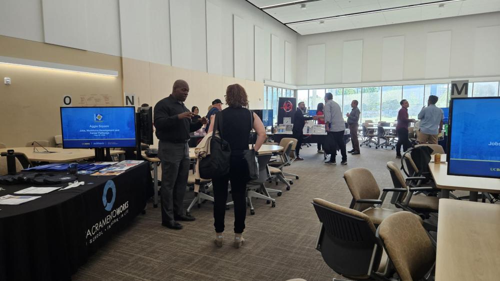 Community members engaging with the organizations at the Aggie Square community meeting.