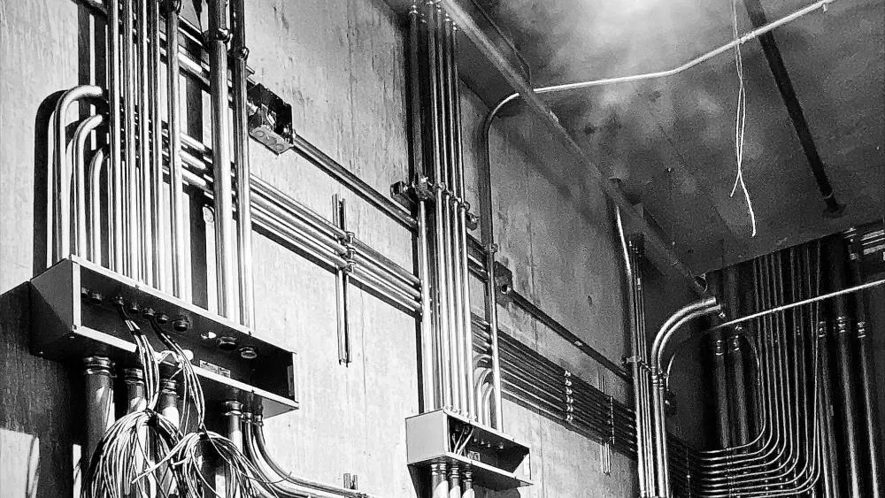 The June 2023 first place winner features a mechanical room with intricately positioned steel pipes managing the wires and cables of multiple systems. Photo by Tom Klein.