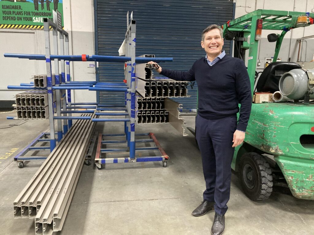 man standing with materials to construct glass windows