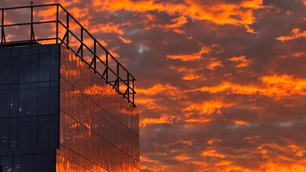 This is the runner-up for October 2023 contest. An orange sky covered in clouds is reflected against one of the glass buildings at Aggie Square. Photo by Brian Jones.