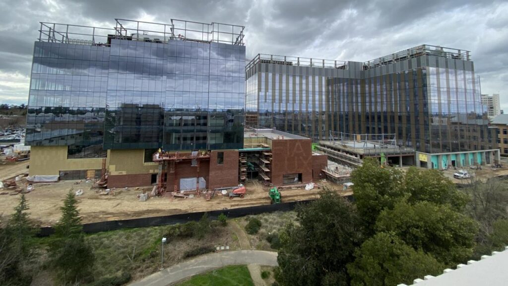 A wide shot of the Aggie Square Buildings with the two-story high brick display. Photo by Tommy DeArmond