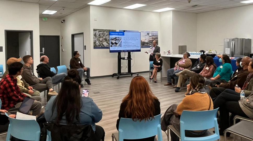 Community engagement meeting group of people looking at a presentation